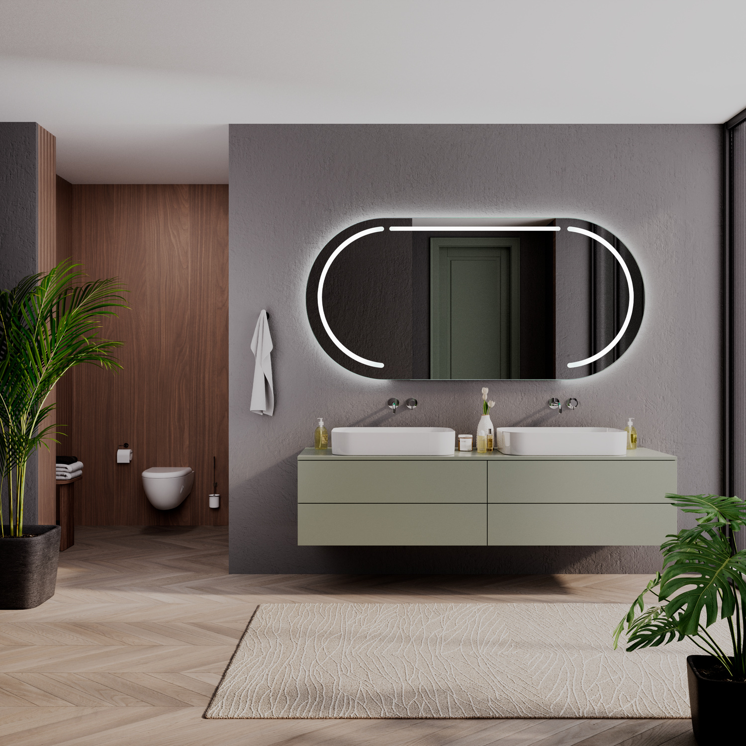 BASTIA OV ovaler LED-Badspiegel mit eingeschalteter Beleuchtung, 1500x1500 mm, leuchtend mit warmweißen Lichtbögen an den Seiten, über zwei weißen rechteckigen Aufsatzwaschbecken auf olivgrünem Waschtisch, luxuriöses Bad mit dunkelgrauer Wand und Grünpfla