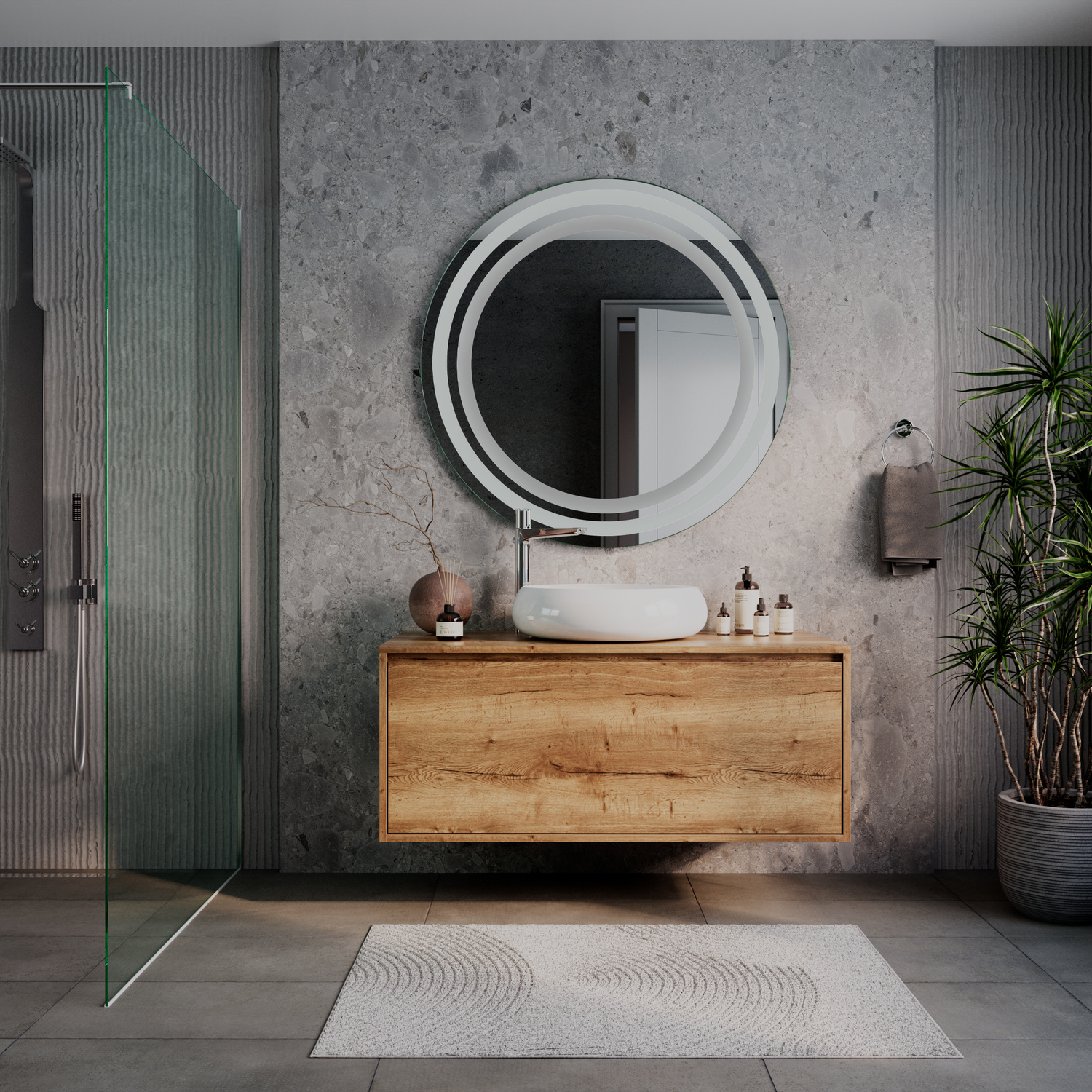 AMOR runder LED-Kosmetikspiegel mit ausgeschalteter Beleuchtung, 1500x1500 mm, freistehend auf modernem Holzwaschtisch, elegantes Bad mit grauer Betonwand, grüner Glastrennwand, Pflanze und weißem Teppich