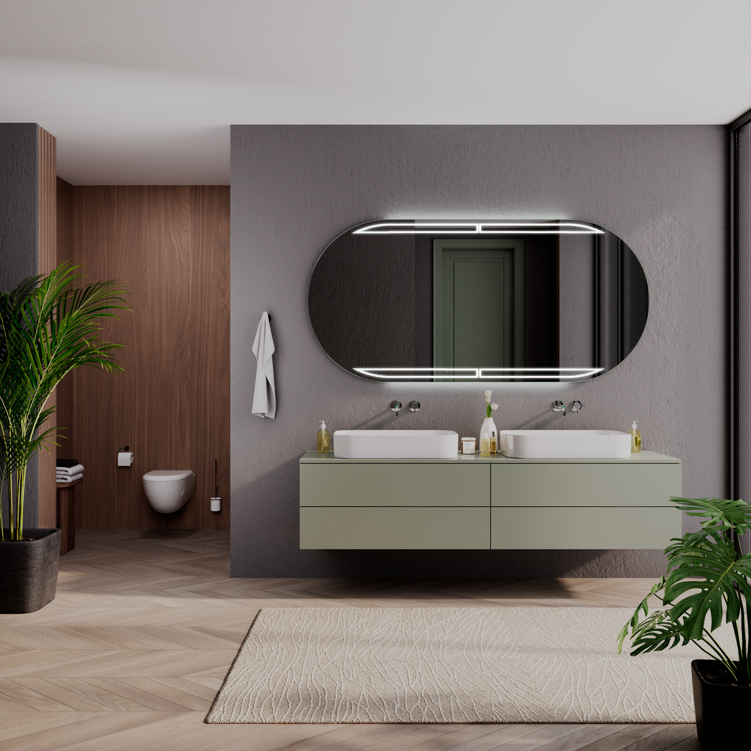 RAM OV LED-Badspiegel mit eingeschalteter Beleuchtung, 1500x1500 mm, ovale Form mit geteilter Spiegelfläche und leuchtendem LED-Lichtrahmen, über zwei weißen rechteckigen Aufsatzwaschbecken auf grünem schwebenden Waschtisch, dunkelgraue Wand, modernes Bad