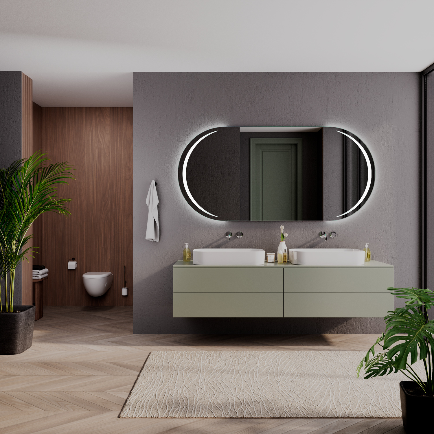 NELAS OV ovaler LED-Badspiegel mit eingeschalteter Beleuchtung, 1500x1500 mm, leuchtend mit warmweißen Lichtbögen an den Seiten, über zwei weißen rechteckigen Aufsatzwaschbecken auf olivgrünem Waschtisch, luxuriöses Bad mit dunkelgrauer Wand und Grünpflan
