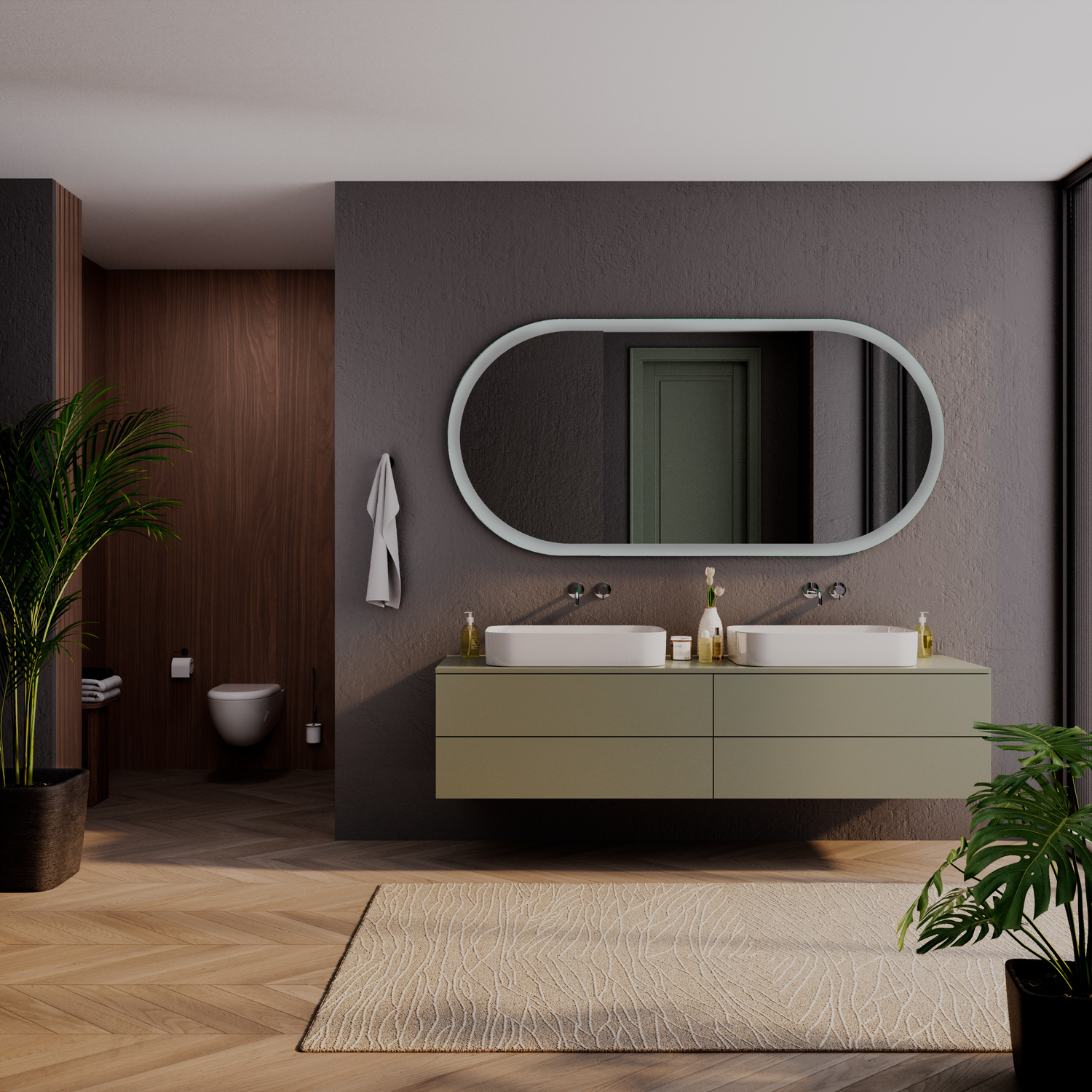 SETE OV40 ovaler LED-Badspiegel mit weißem Rahmen, 1500x1500 mm, Beleuchtung ausgeschaltet, über olivgrünem schwebenden Waschtisch mit zwei weißen rechteckigen Aufsatzwaschbecken, modernes Bad mit grauer Wand, Holzboden und großen Pflanzen