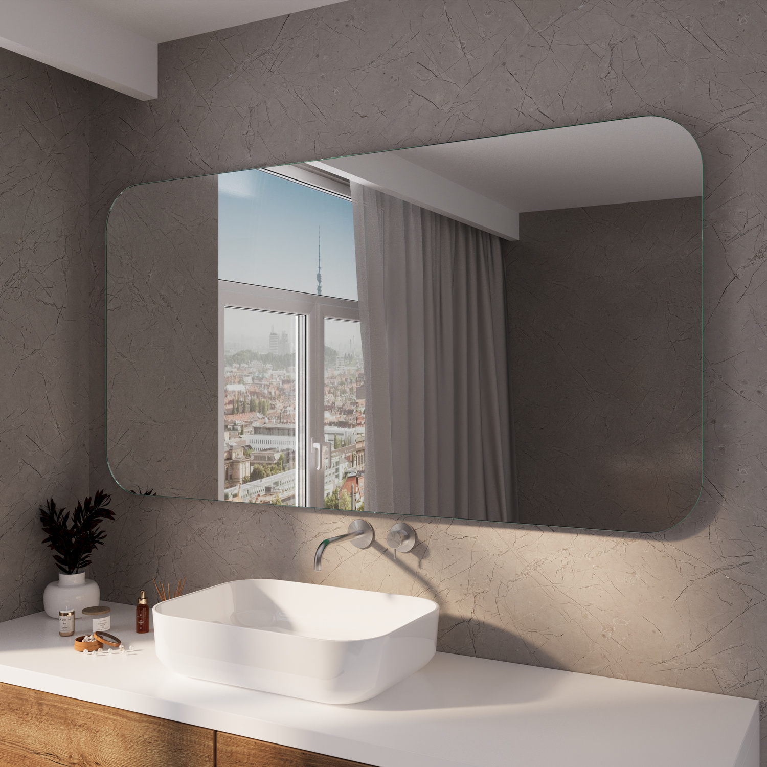 Kristallspiegel mit abgerundeten Ecken über einem weißen Aufsatzwaschbecken in einem modernen Badezimmer mit Betonoptik-WändenRetry